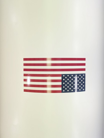 Huge (3-4 people long) USA flag on the side of the Saturn V rocket.