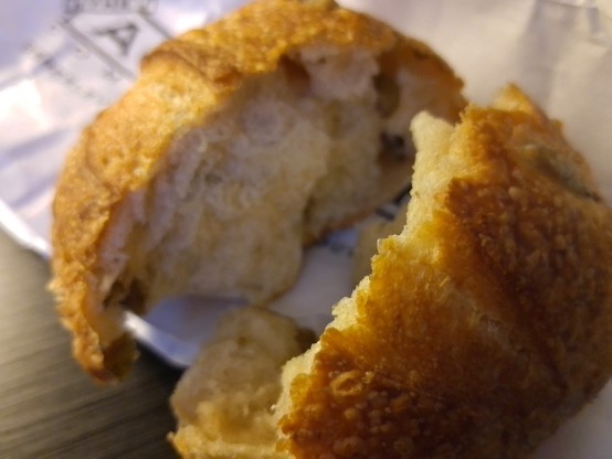 A small olive sourdough bun.