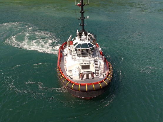 A tug boat guiding our ferry in.
