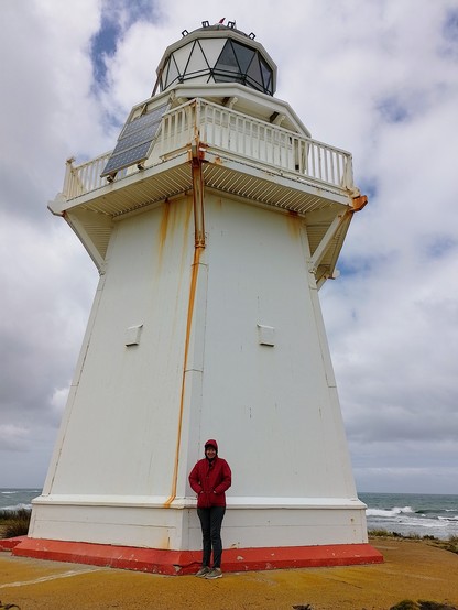 Sally at the Waipapa Point lighthouse. Made of totara and kauri with sections of rock ballast. The lighthouse is also made of wood.