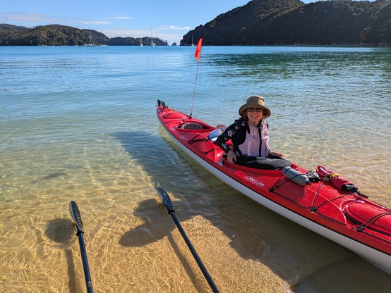 Sally getting into the kayak after a stop at Anchorage in Torrent Bay. Nice clear water