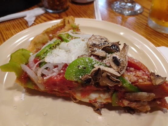 Chicago deep dish pizza. Dough topped with cheese topped with sausage and then tomato and veges.