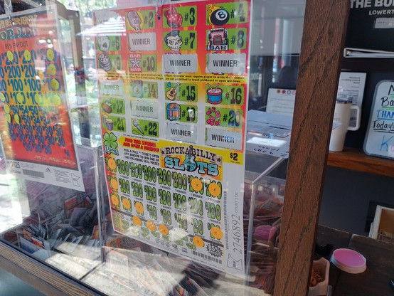 A perspex box of cards with a display showing which prizes have been won.