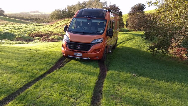 The van firmly stuck on the grassy bit of the driveway at the bach.