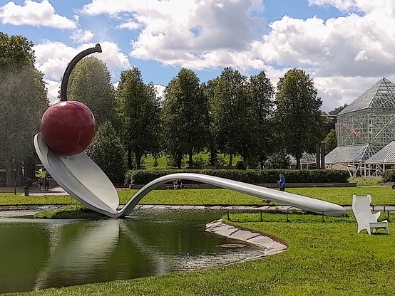 Spoon bridge with cheery sculpture.