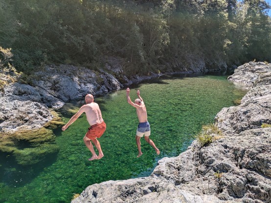 Damian and John jumping off rocks