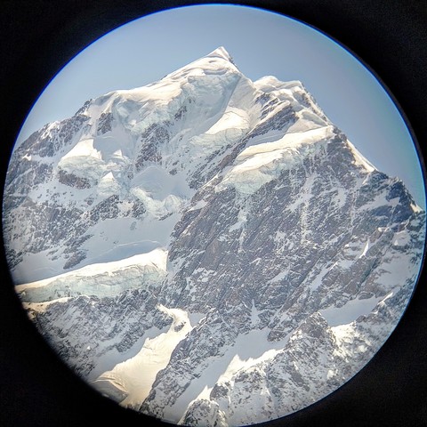 Aoraki/Mt Cook viewed through binoculars from Hooker Lake.
