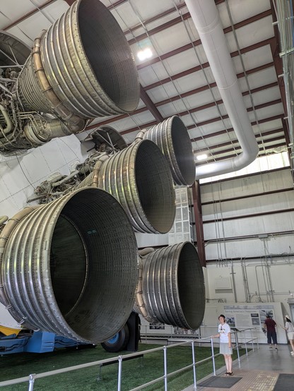 Sally for scale beside the Saturn V's stage 1 five primary engines.